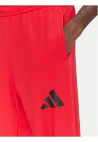 Adidas - adidas Spodnie dresowe Essentials JF3601 Czerwony Loose Fit. Kolor: czerwony. Materiał: bawełna #5
