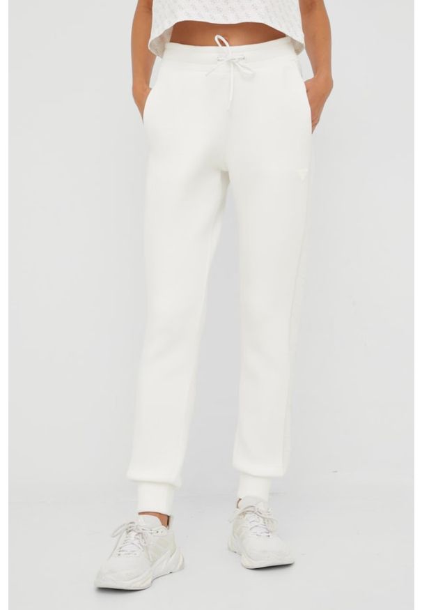 Guess - GUESS Beżowe spodnie dresowe damskie Allie Scuba, Rozmiar L. Kolor: beżowy. Materiał: dresówka