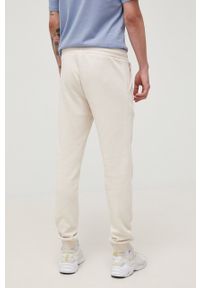 Jack & Jones spodnie męskie kolor beżowy z nadrukiem. Kolor: beżowy. Materiał: dzianina. Wzór: nadruk