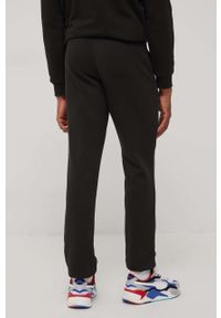 Puma spodnie 586720 męskie kolor czarny z nadrukiem. Kolor: czarny. Materiał: materiał, dzianina. Wzór: nadruk #4