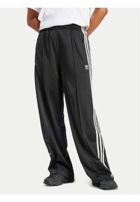 Adidas - adidas Spodnie dresowe Firebird IT7404 Czarny Regular Fit. Kolor: czarny. Materiał: syntetyk