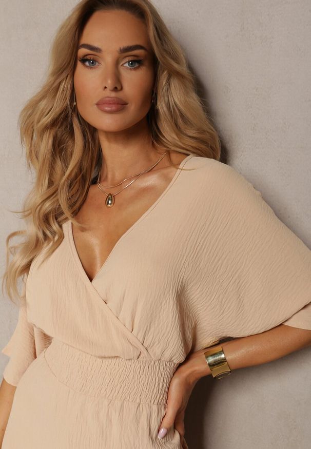 Renee - Beżowy Kombinezon o Kopertowym Fasonie z Szerokim Luźnym Dołem i Kieszeniami Octoni. Okazja: na co dzień. Kolor: beżowy. Styl: casual, elegancki