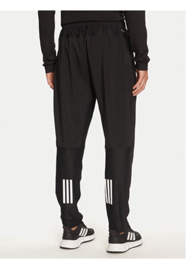 Adidas - adidas Spodnie dresowe Own The Run IK5024 Czarny Regular Fit. Kolor: czarny. Materiał: syntetyk. Sport: bieganie