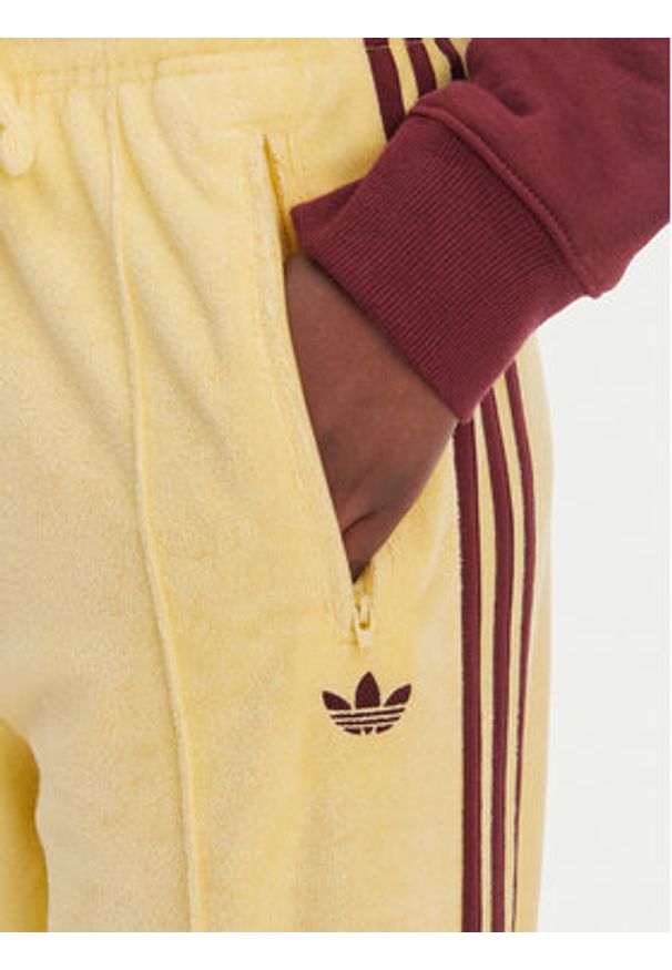 Adidas - adidas Spodnie dresowe Terry Towel Firebird KQ6662 Żółty Loose Fit. Kolor: żółty. Materiał: bawełna