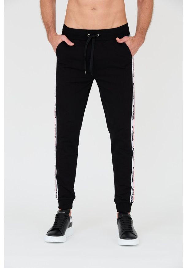 MOSCHINO Czarne męskie spodnie dresowe z lampasami, Rozmiar L. Kolor: czarny. Materiał: dresówka