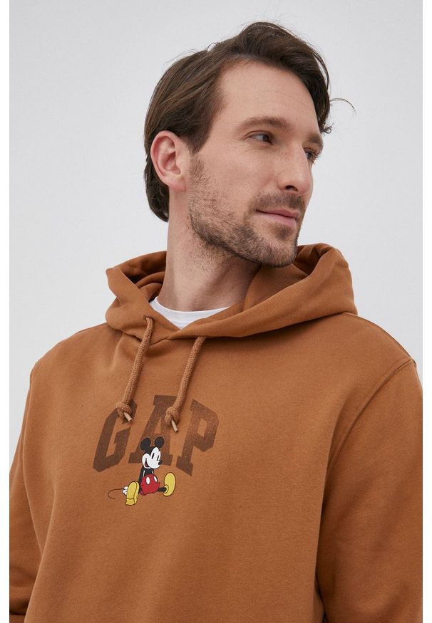 GAP Bluza x Disney kolor brązowy z kapturem z nadrukiem. Typ kołnierza: kaptur. Kolor: brązowy. Materiał: poliester, dzianina. Wzór: nadruk, motyw z bajki