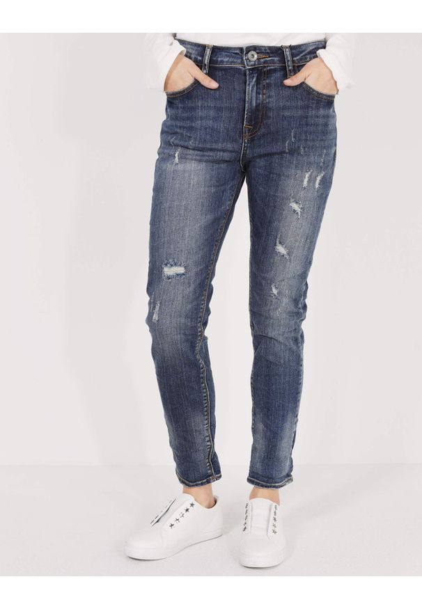 Unisono - JEANSY Z PRZETARCIAMI 42-7137 JEAN J20. Materiał: jeans