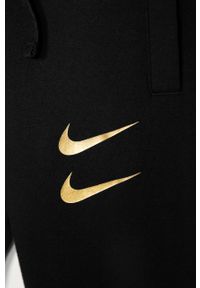 Nike Kids - Spodnie dziecięce 122-170 cm. Kolor: czarny. Materiał: bawełna, poliester, dzianina. Wzór: nadruk #3