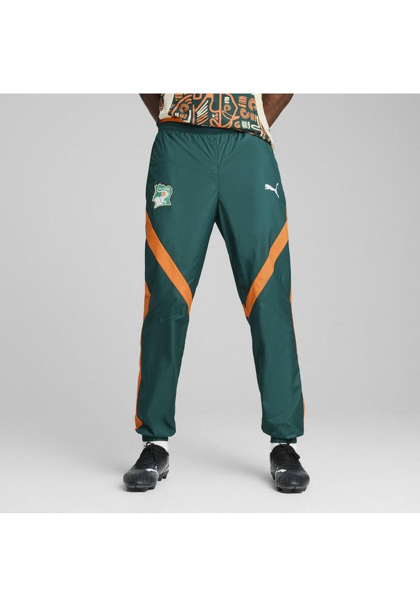 Puma - Męskie spodnie przedmeczowe Wybrzeża Kości Słoniowej 2025 z tkaniny PUMA. Kolor: pomarańczowy, żółty, wielokolorowy, zielony. Materiał: tkanina. Sport: piłka nożna