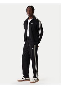 Adidas - adidas Spodnie dresowe Firebird KD8315 Czarny Loose Fit. Kolor: czarny. Materiał: syntetyk #3