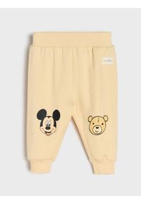 Sinsay - Spodnie z polarem w środku Mickey Mouse - kremowy. Kolor: kremowy. Materiał: polar. Wzór: motyw z bajki