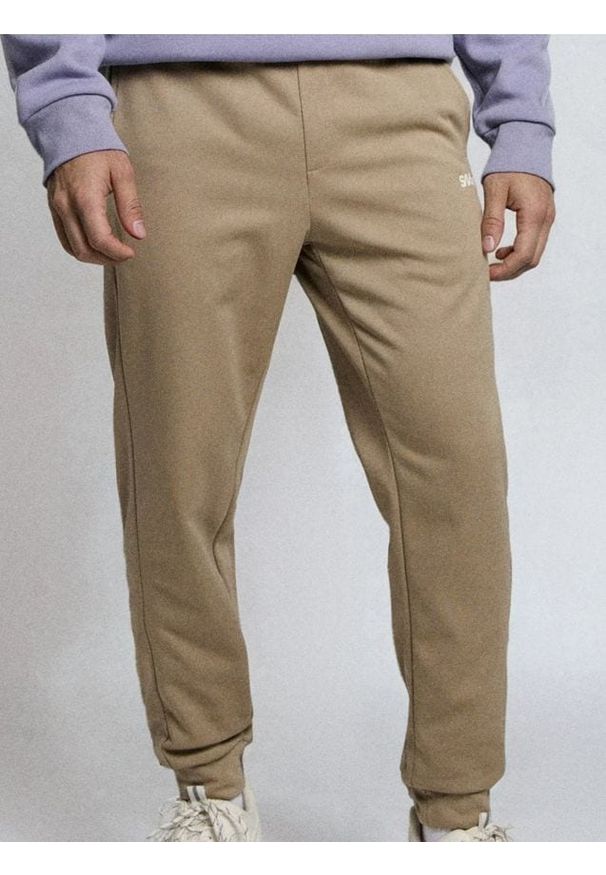 Sinsay - Spodnie dresowe jogger - beżowy. Kolor: beżowy. Materiał: dresówka