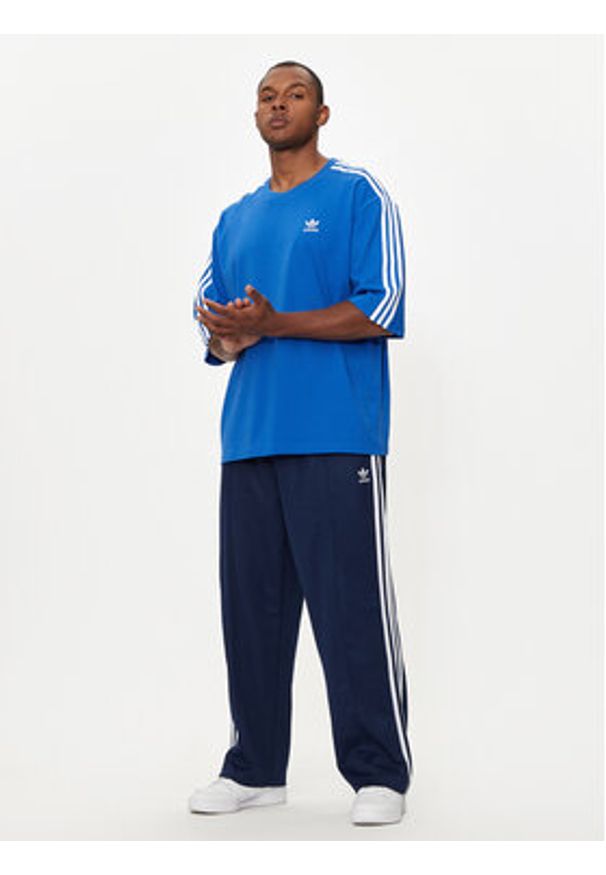 Adidas - adidas Spodnie dresowe adicolor Firebird IZ2466 Granatowy Baggy Fit. Kolor: niebieski. Materiał: bawełna