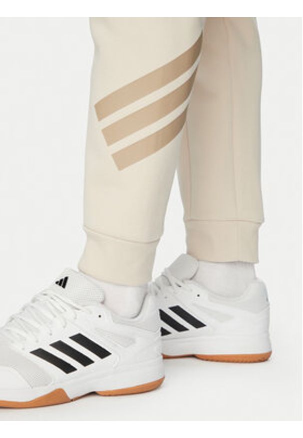 Adidas - adidas Spodnie dresowe Future Icons 3-Stripes KD5206 Beżowy Regular Fit. Kolor: beżowy. Materiał: bawełna