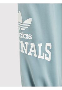 Adidas - adidas Spodnie dresowe Graphic Print HL6883 Niebieski Relaxed Fit. Kolor: niebieski. Materiał: syntetyk. Wzór: nadruk