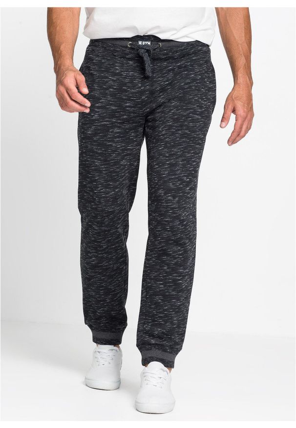 bonprix - Melanżowe spodnie sportowe ze ściągaczem. Kolor: czarny. Wzór: melanż, prążki. Styl: sportowy