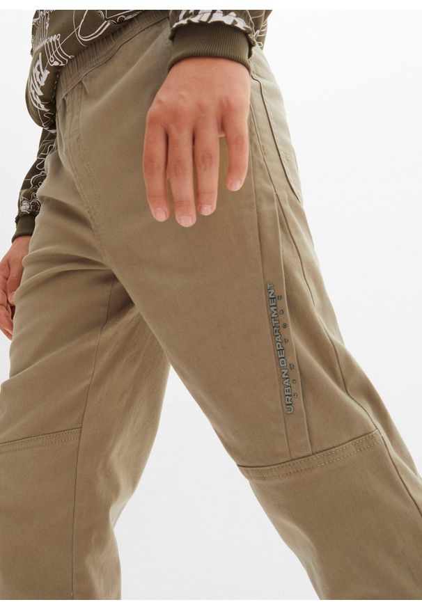 bonprix - Spodnie typu loose fit z podszewką z dżerseju. Kolor: zielony. Materiał: jersey