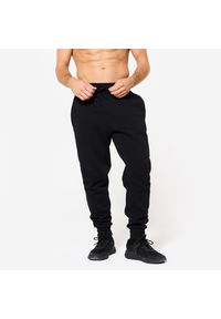DOMYOS - Spodnie fitness męskie Domyos Gym & Pilates slim. Kolor: niebieski. Materiał: dresówka, dzianina, materiał. Wzór: ze splotem. Sport: joga i pilates, fitness