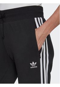 Adidas - adidas Spodnie dresowe Adicolor Classics Slim Cuffed Joggers IB7455 Czarny Slim Fit. Kolor: czarny. Materiał: bawełna