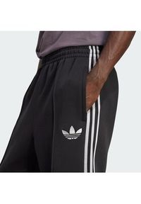Adidas - adidas Spodnie dresowe adicolor Spacer Track JX1506 Czarny Baggy Fit. Kolor: czarny. Materiał: bawełna. Sport: turystyka piesza #4