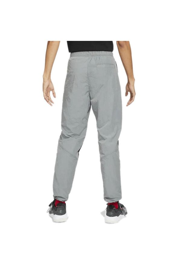 Nike - Spodnie męskie nike air jordan flight suit pants smoke grey. Kolor: wielokolorowy, szary, czarny. Model: Nike Air Jordan. Sport: bieganie