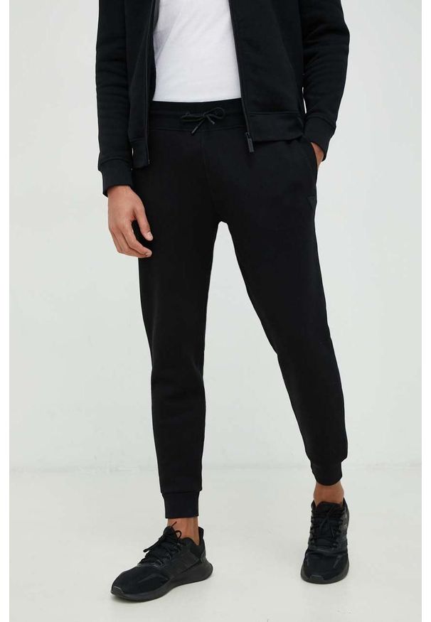 Guess spodnie dresowe kolor czarny melanżowe. Kolor: czarny. Materiał: dresówka. Wzór: melanż