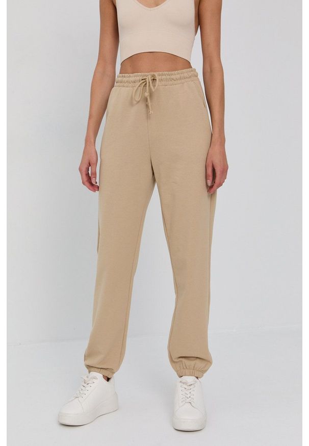 Vero Moda Spodnie damskie kolor beżowy gładkie. Kolor: beżowy. Materiał: bawełna, materiał, dzianina. Wzór: gładki