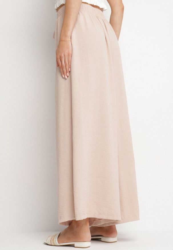 Born2be - Beżowe Szerokie Spodnie Typu Palazzo z Wiązaniem Ulialitia. Okazja: na co dzień. Stan: podwyższony. Kolor: beżowy. Styl: elegancki, casual