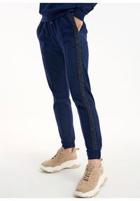 Ochnik - Spodnie dresowe z lampasami damskie. Kolor: niebieski. Materiał: wiskoza