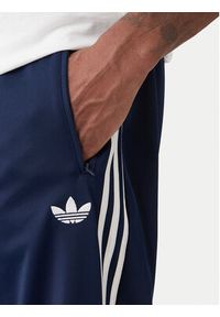 Adidas - adidas Spodnie dresowe Firebird KD8316 Granatowy Loose Fit. Kolor: niebieski. Materiał: syntetyk #3