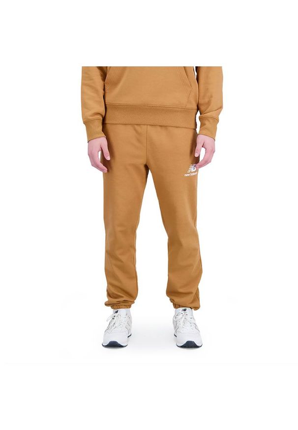 Spodnie New Balance MP31539TOB - brązowe. Kolor: brązowy. Materiał: bawełna, poliester, tkanina, dresówka