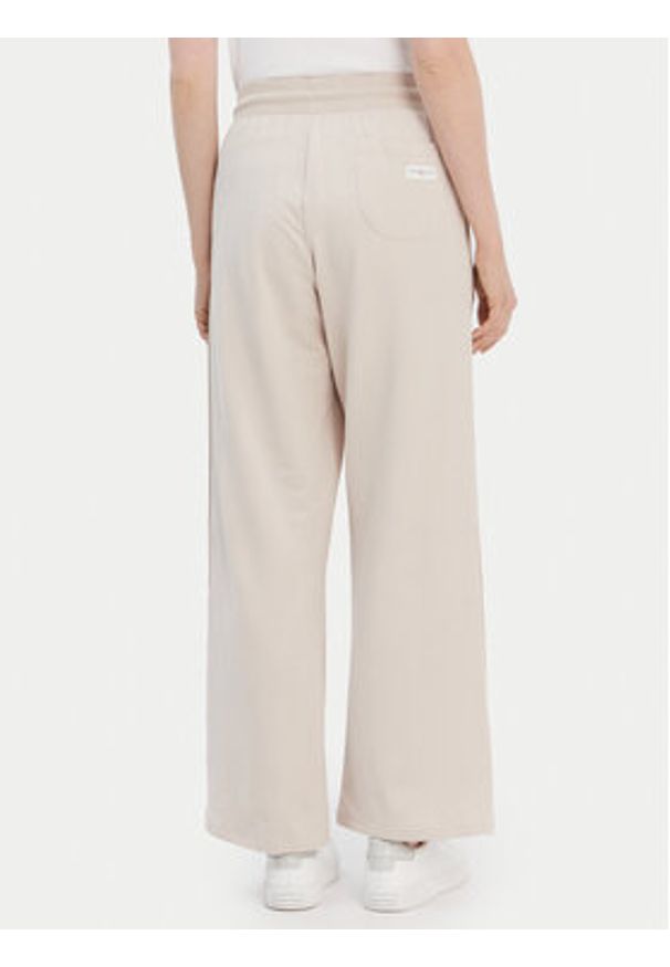 TOMMY HILFIGER - Tommy Hilfiger Spodnie dresowe UW0UW04771 Beżowy Relaxed Fit. Kolor: beżowy. Materiał: dresówka