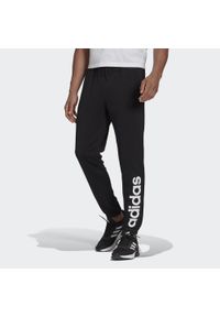 Adidas - Spodnie adidas Essentials Tapered Elastic Cuff Linear. Kolor: czarny. Materiał: bawełna. Sport: fitness