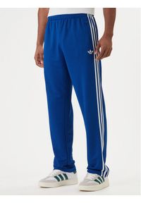 Adidas - adidas Spodnie dresowe adicolor Firebird KD4079 Niebieski Regular Fit. Kolor: niebieski. Materiał: syntetyk #1