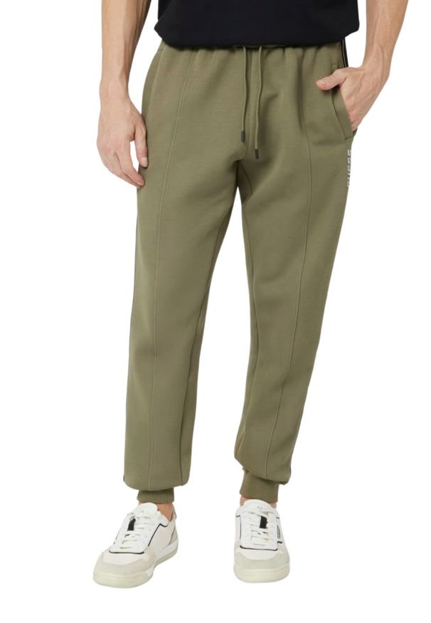 Guess - GUESS Zielone męskie spodnie dresowe z lampasami Mickey, Rozmiar XL. Kolor: zielony. Materiał: dresówka