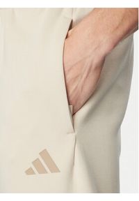 Adidas - adidas Spodnie dresowe Future Icons 3-Stripes KD5206 Beżowy Regular Fit. Kolor: beżowy. Materiał: bawełna #5