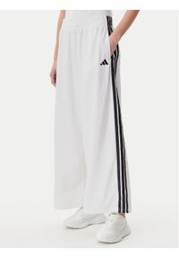 Adidas - adidas Spodnie dresowe Essentials 3-Stripes JE1307 Biały Loose Fit. Kolor: biały. Materiał: syntetyk #1