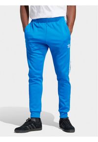 Adidas - adidas Spodnie dresowe adicolor Classics SST IM4542 Niebieski Slim Fit. Kolor: niebieski. Materiał: bawełna