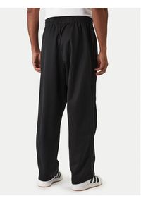 Adidas - adidas Spodnie dresowe adicolor KE3500 Czarny Loose Fit. Kolor: czarny. Materiał: bawełna, syntetyk #3