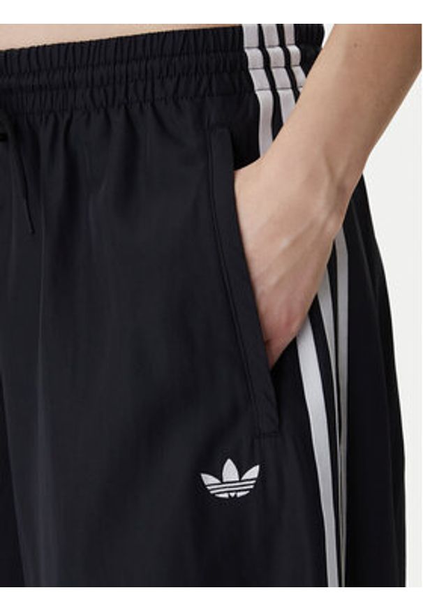 Adidas - adidas Spodnie dresowe Firebird Adilenium KD2914 Czarny Regular Fit. Kolor: czarny. Materiał: syntetyk