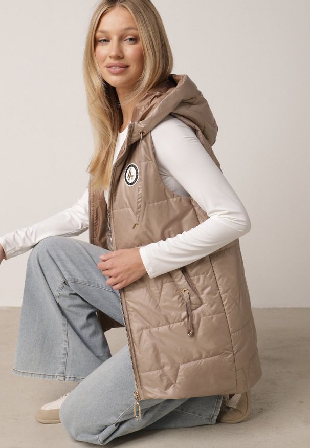 Born2be - Brązowa Pikowana Kamizelka o Długim Kroju z Nieodpinanym Kapturem i Aplikacją Koretes. Okazja: na co dzień. Kolor: brązowy. Materiał: prążkowany, poliester. Długość: długie. Wzór: aplikacja. Styl: casual