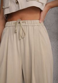 Renee - Beżowe Szerokie Spodnie Wiskozą Bawełną i Elastyczną Talią ze Sznurkiem Arkinae. Okazja: na co dzień. Stan: podwyższony. Kolor: beżowy. Materiał: wiskoza, bawełna. Wzór: aplikacja. Styl: casual #6