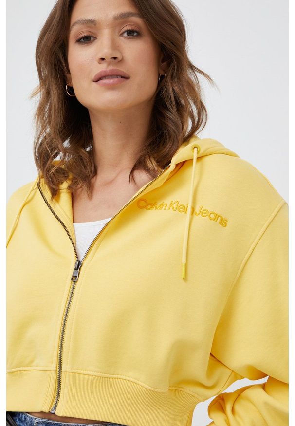 Calvin Klein Jeans bluza bawełniana damska kolor żółty z kapturem gładka. Typ kołnierza: kaptur. Kolor: żółty. Materiał: bawełna. Wzór: gładki