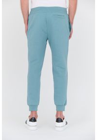 Guess - GUESS Turkusowe spodnie dresowe Aldwin. Kolor: niebieski. Materiał: dresówka