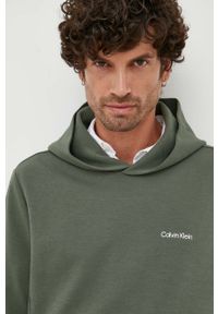 Calvin Klein bluza męska kolor zielony z kapturem gładka. Typ kołnierza: kaptur. Kolor: zielony. Długość rękawa: długi rękaw. Długość: długie. Wzór: gładki #1