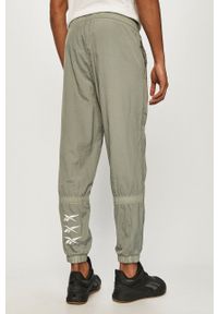 Reebok - Spodnie. Kolor: zielony. Materiał: tkanina #4