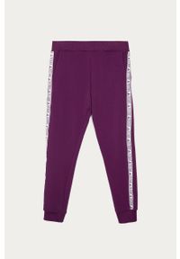 Guess Jeans - Spodnie dziecięce 116-175 cm. Kolor: fioletowy. Materiał: bawełna, jeans, dzianina, elastan. Wzór: aplikacja #1