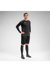 UHLSPORT - Dziecięcy dżersej z długim rękawem Uhlsport Squad 27. Kolor: wielokolorowy, czarny, szary, brązowy. Materiał: jersey. Długość rękawa: długi rękaw. Długość: długie