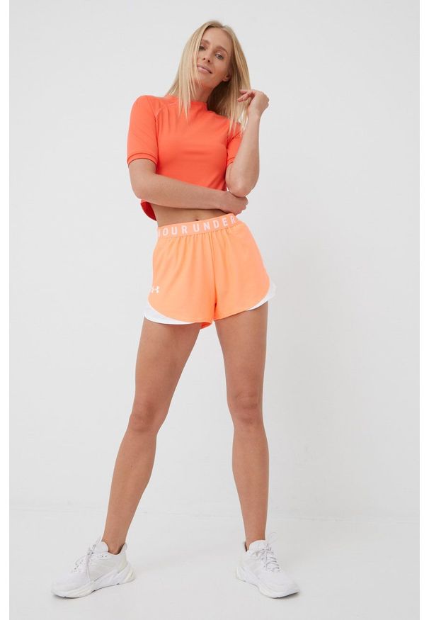 Under Armour Szorty 1344552 damskie kolor pomarańczowy z aplikacją medium waist. Okazja: na co dzień. Kolor: pomarańczowy. Wzór: aplikacja. Styl: casual