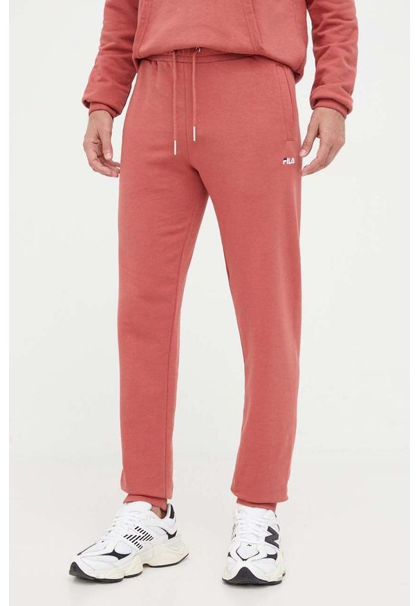 Fila spodnie dresowe kolor różowy gładkie. Kolor: różowy. Materiał: dresówka. Wzór: gładki